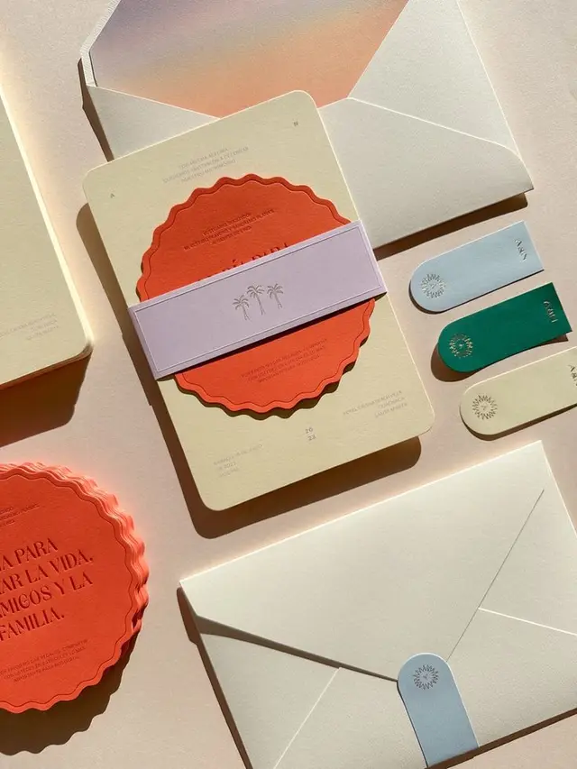 Tropical coral scallop invitation suite — flat‑lay stationery