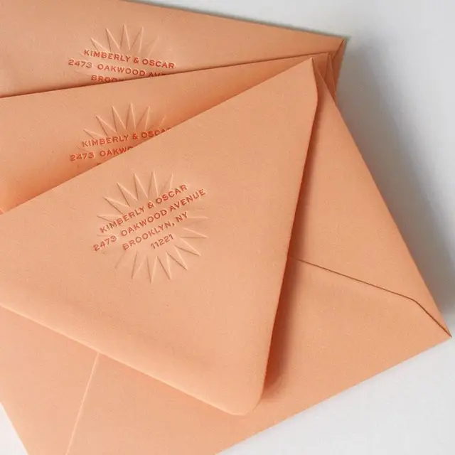 Peach embossed envelopes with custom return address (Kimberly & Oscar)