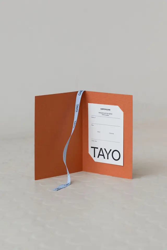Orange textured folio with TAYO certificate and blue branded ribbon