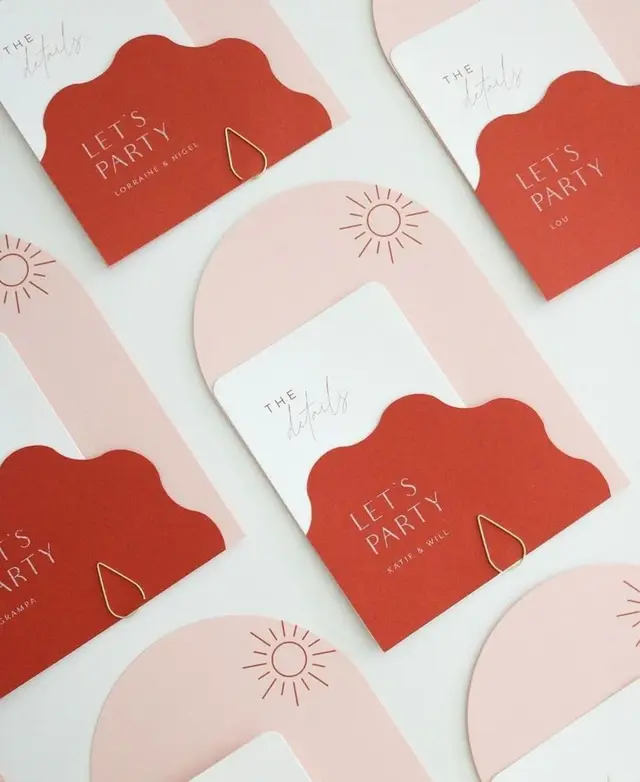 Scalloped terracotta 'LET'S PARTY' invitations in pink arch pockets