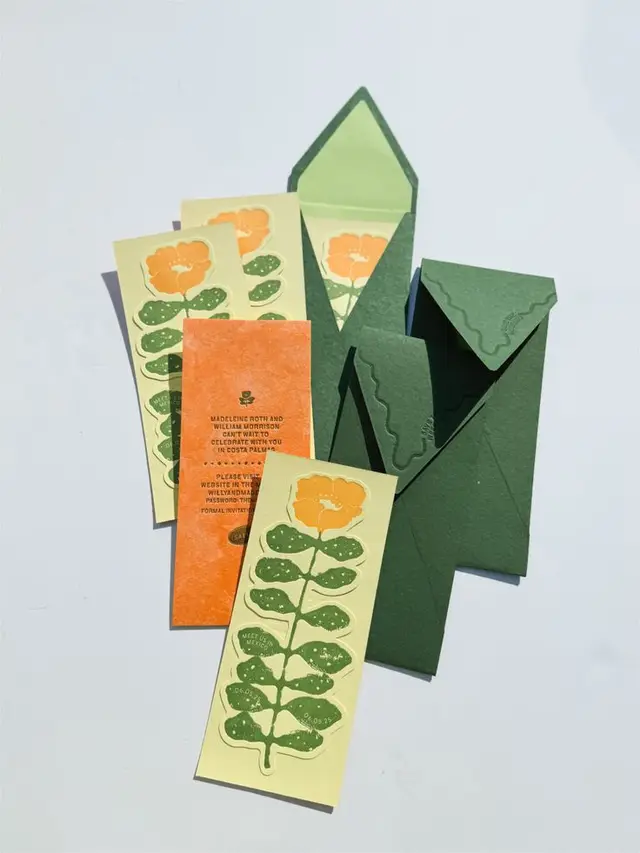 Forest-green embossed envelopes with yellow-orange poppy bookmark cards