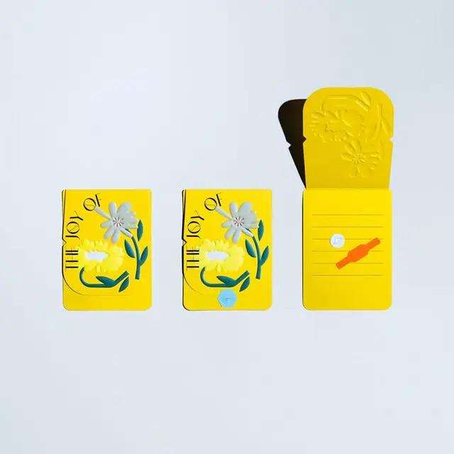Yellow die-cut floral matchbook notepads — "The Joy Of"