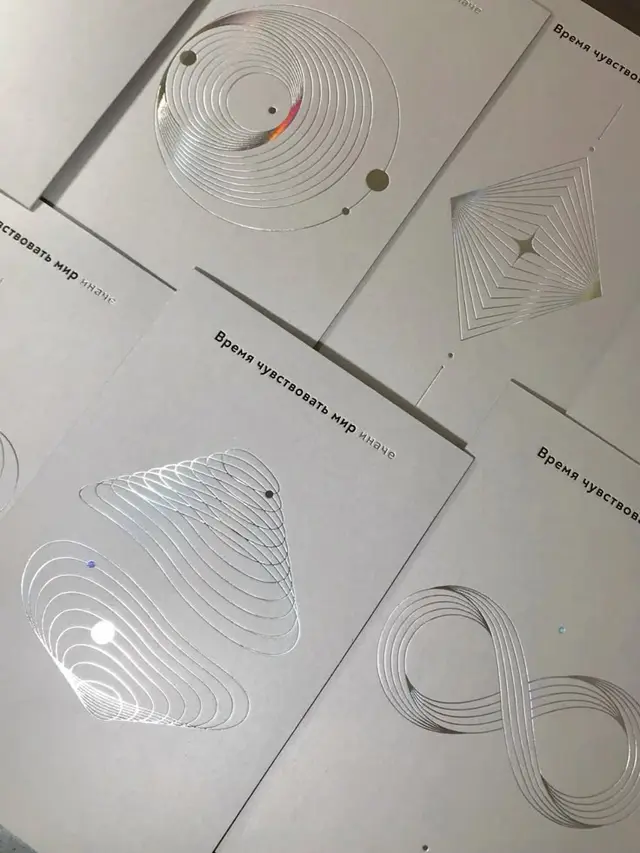 White cardstock cards with silver-foil geometric motifs and Russian headline