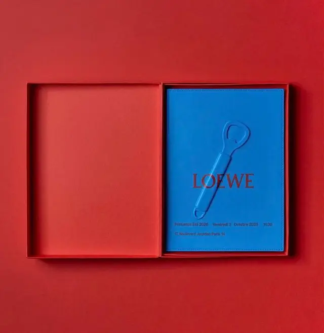 LOEWE blue leather booklet with embossed bottle-opener in red presentation box