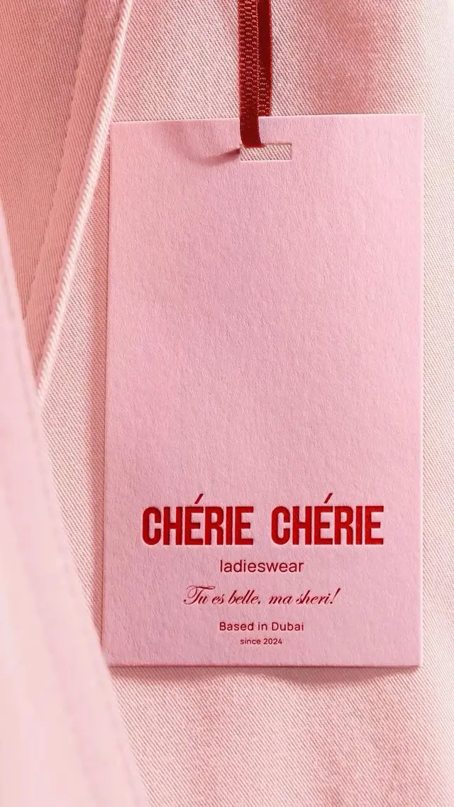 CHÉRIE CHÉRIE pink hang tag on blush garment