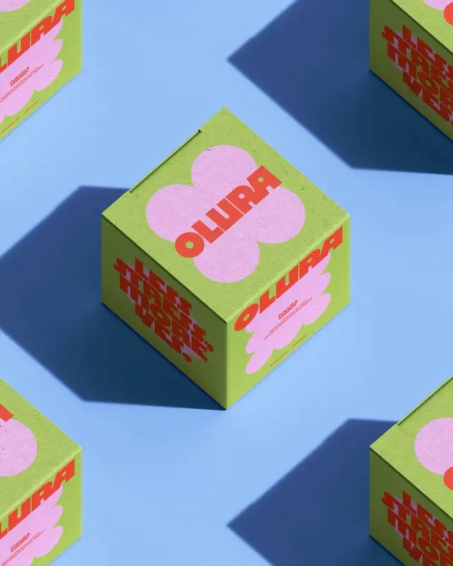 OLUPA lime-green paperboard cube with pink clover graphic