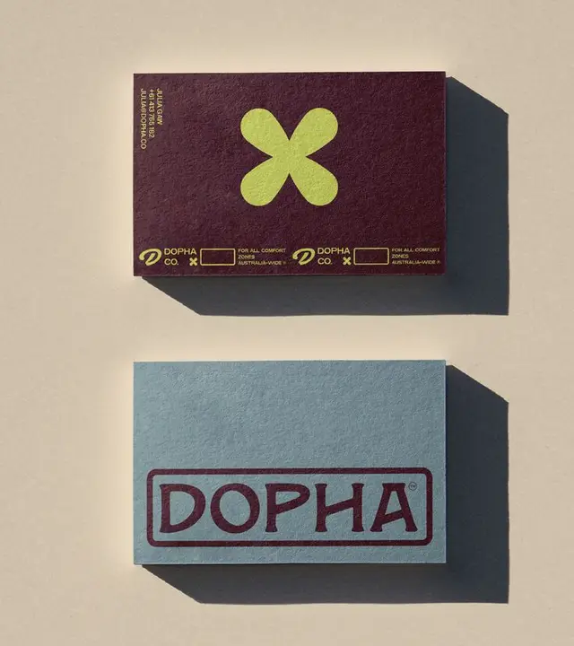 DOPHA branded business cards — burgundy & powder-blue textured letterpress