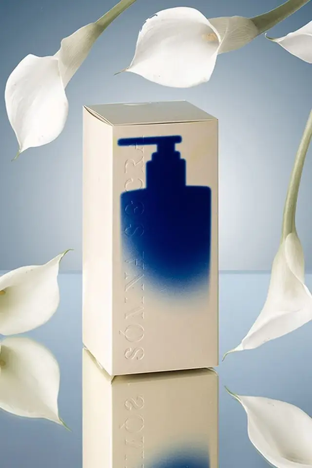Cream skincare box with blue pump silhouette and calla lilies