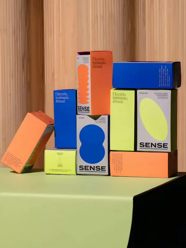 Bold color-blocked packaging stack for 'SENSE' brand