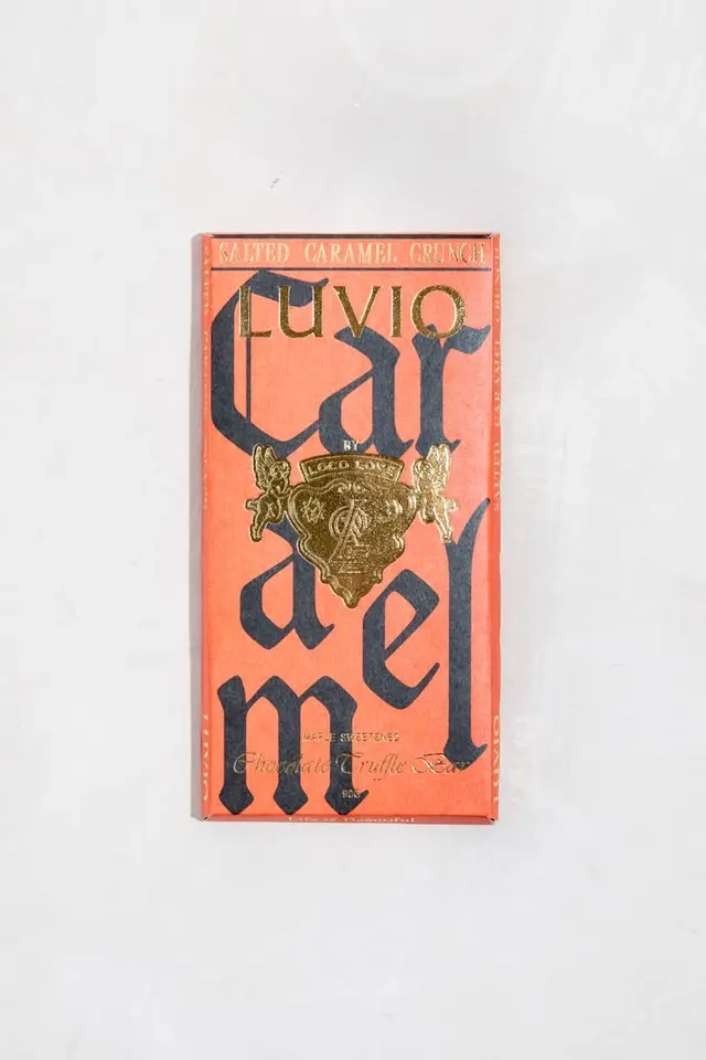 Salted Caramel Crunch chocolate bar box — coral-orange packaging with gold foil crest