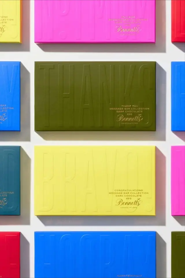 Bennett's embossed message-bar chocolate packaging — bright color-block boxes