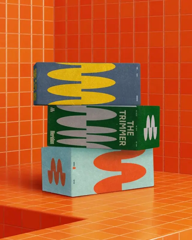 Stacked mid-century packaging boxes with wavy graphics on orange tile