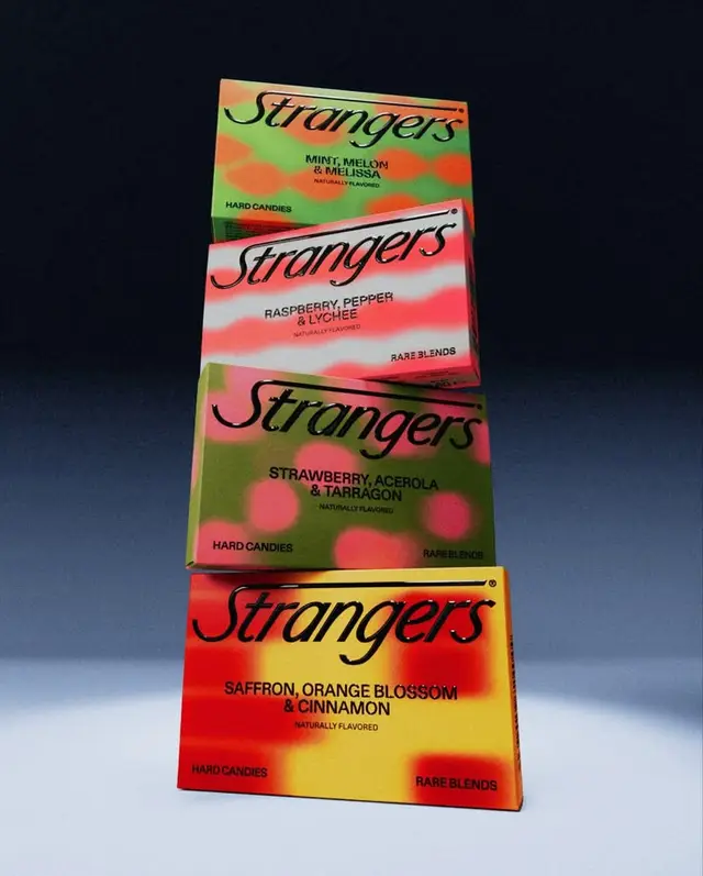 Strangers — stacked limited‑edition candy boxes (saffron, strawberry, raspberry, mint)