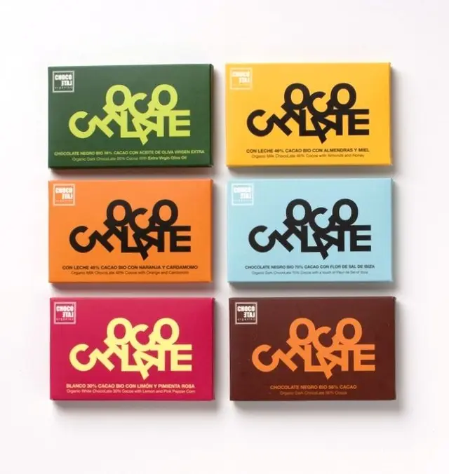 Six color‑coded organic chocolate bar packages with bold typographic logo