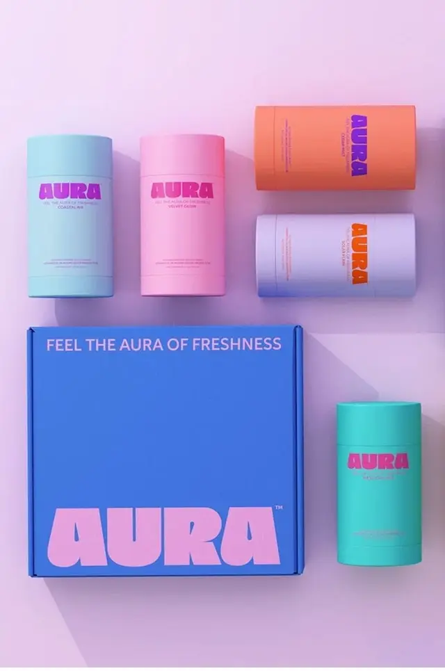 AURA pastel packaging flat-lay — deodorant sticks and branded box