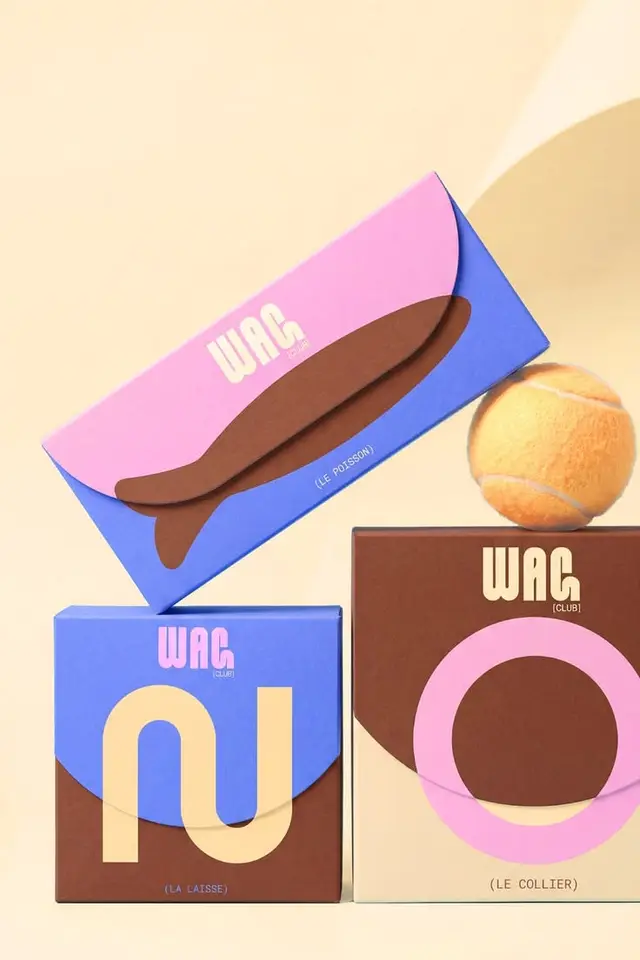 WAG pastel product packaging — stacked boxes with graphic fish and tennis ball