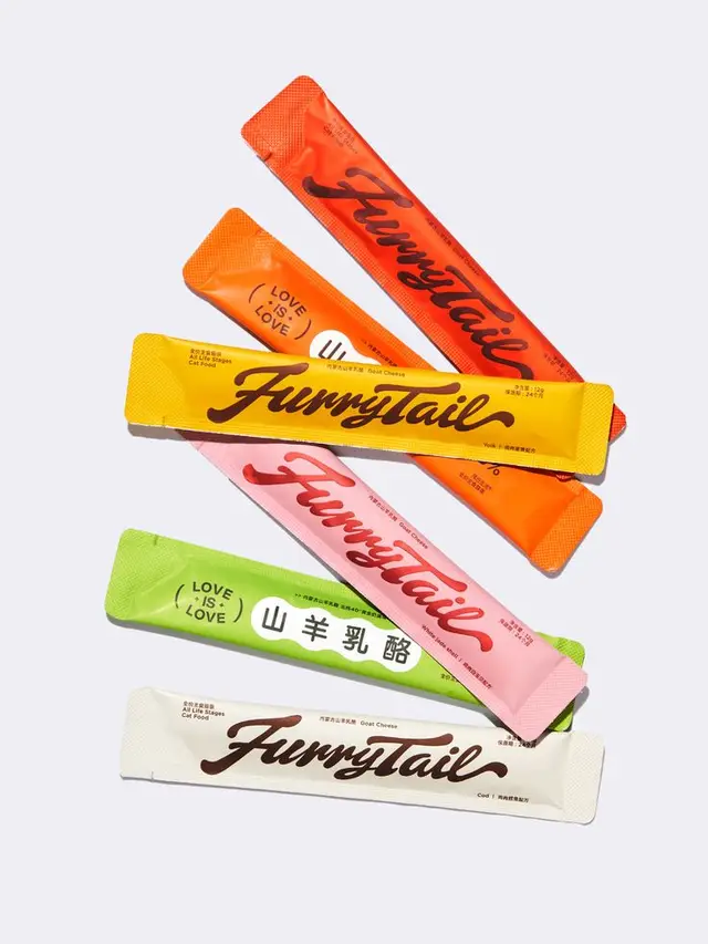 Furrytail colorful single‑serve stick sachets — flat‑lay packaging photo