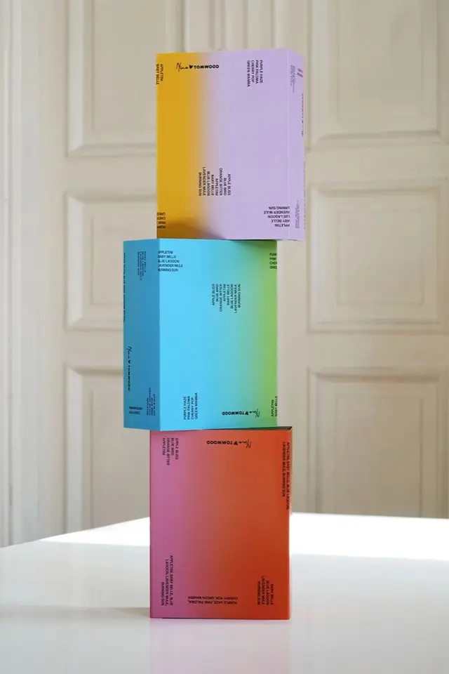 Stacked gradient product boxes with TOMWOOD logo