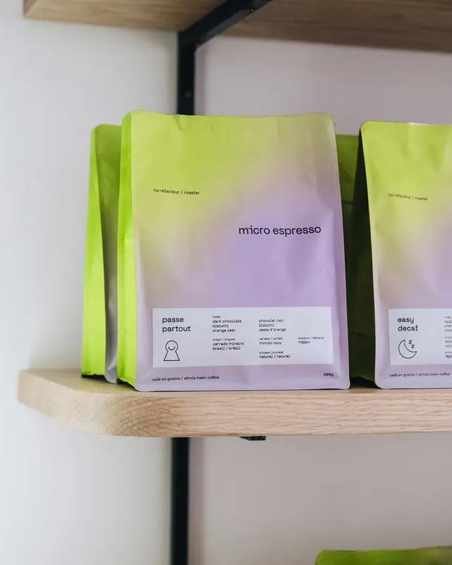 Pastel gradient coffee packaging — "micro espresso" bags on oak shelf