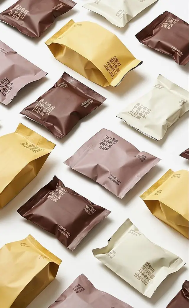 Minimal Snack Pouch Packaging — Matte Mustard, Brown, Mauve, Cream (Flat-lay)