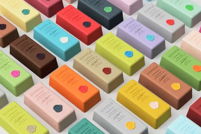 Pastel rectangular candle boxes with colored wax-seal labels