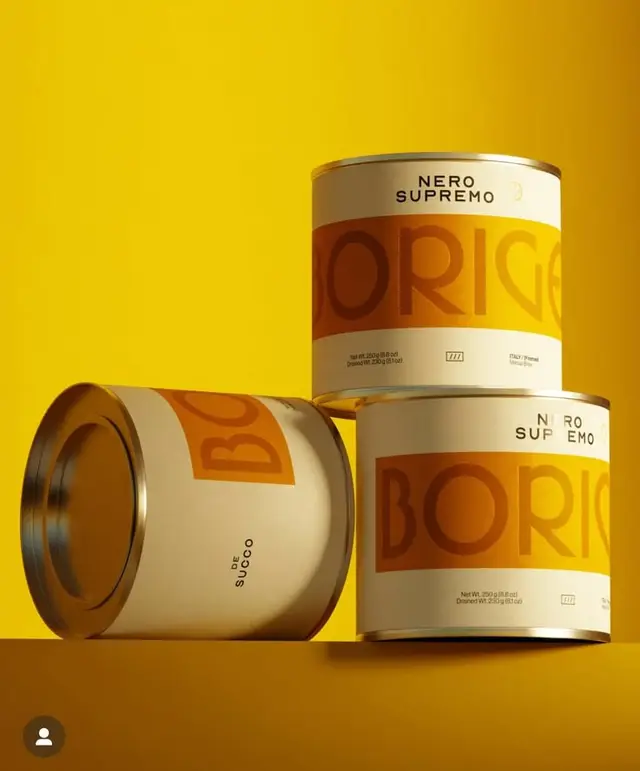 Yellow packaging mockup: 'NERO SUPREMO' metal tins with bold orange band