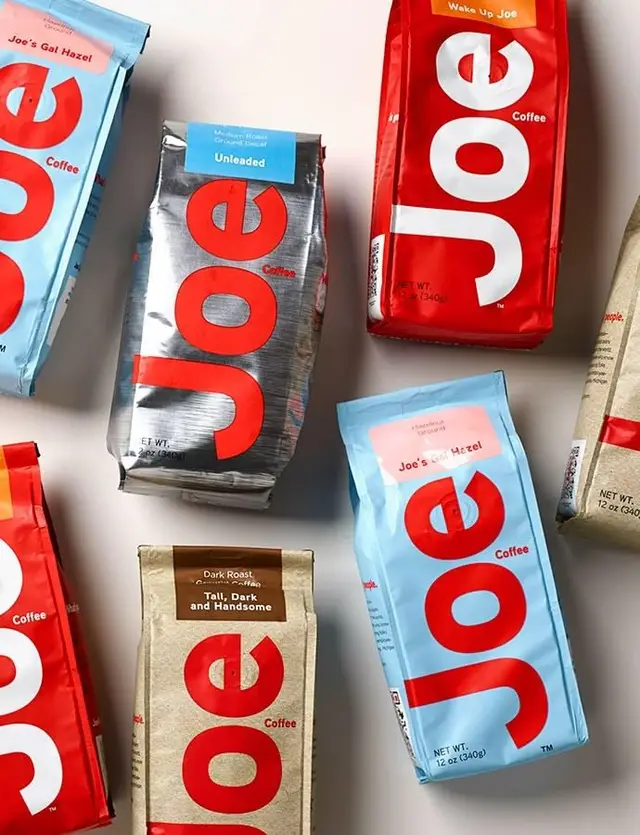 Joe Coffee packaging — bold red logotype on foil and kraft bags