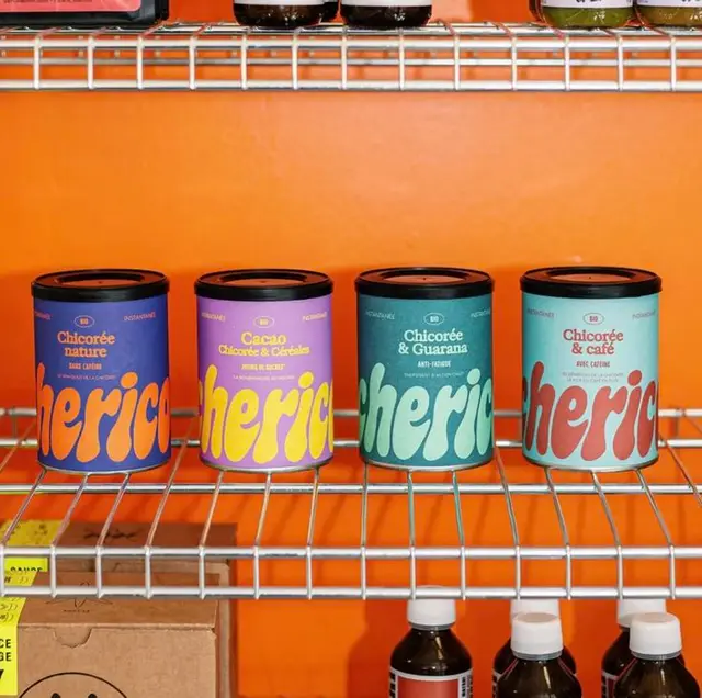 Colorful Chicorée powder tins on chrome wire retail shelf