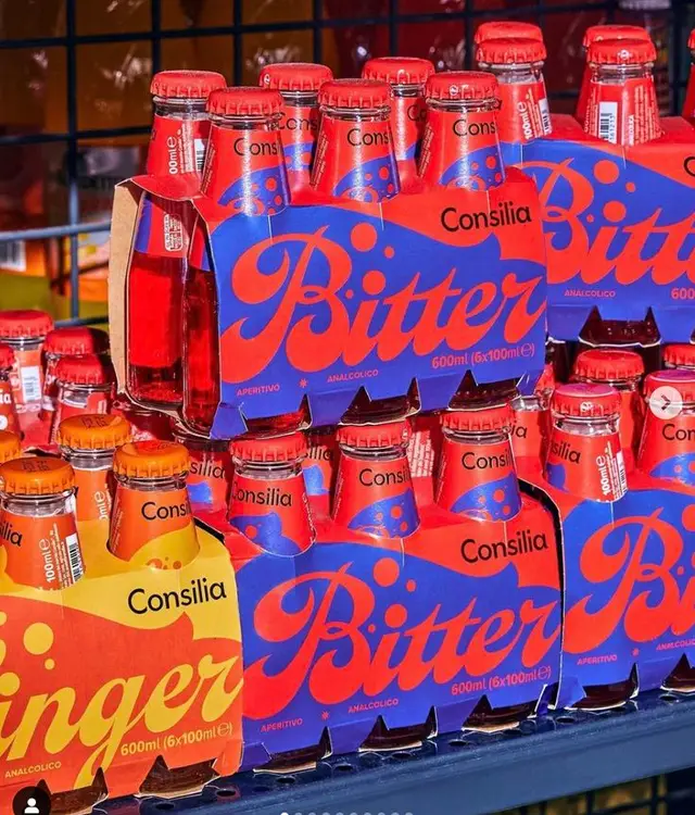 Consilia Bitter and Ginger six‑pack display — bold red & blue packaging