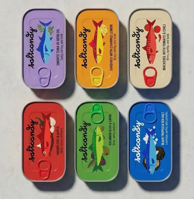 Six colorful tinned fish cans with illustrated flavor labels
