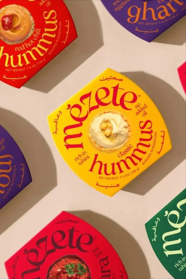 Mezete hummus hexagonal packaging flat-lay — multi-flavor lineup