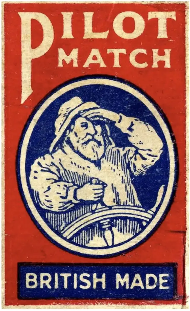 Vintage PILOT MATCH British matchbox label with bearded sailor steering a ship's wheel