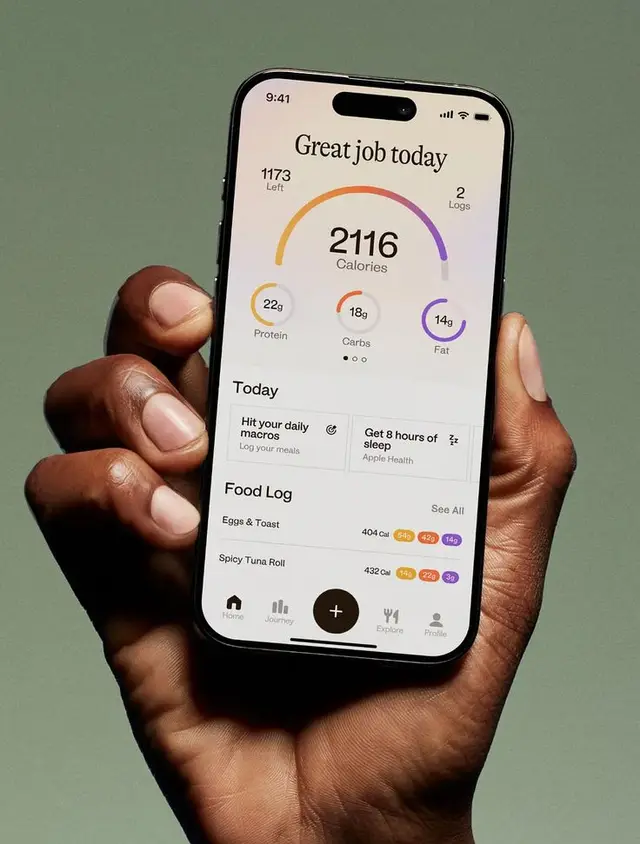 Calorie-tracking app dashboard on smartphone held in hand