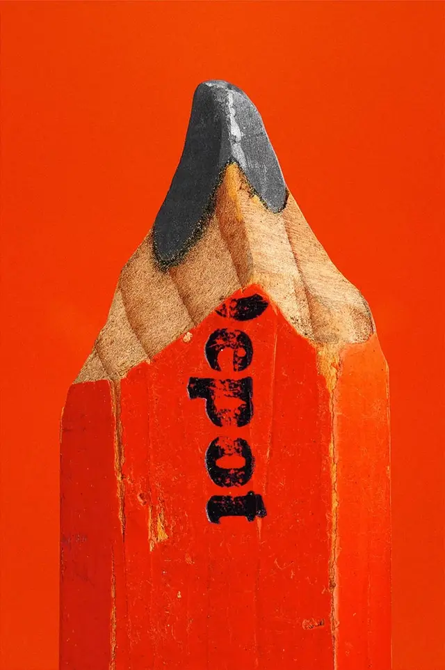 Close-up of worn orange carpenter pencil tip with black stamped lettering