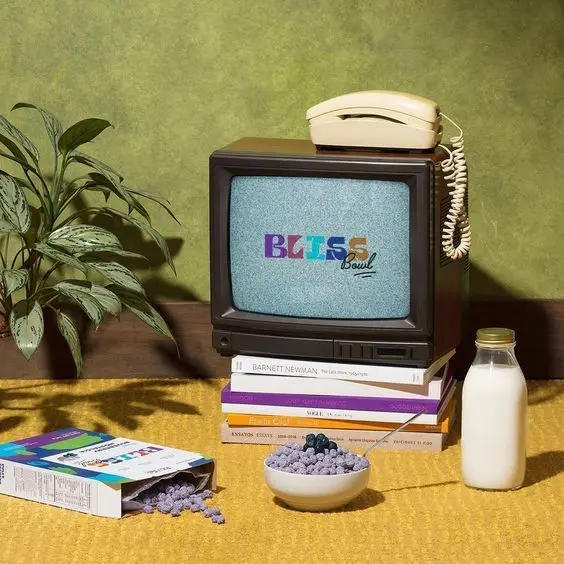 Retro still life: vintage TV, corded phone, purple cereal bowl