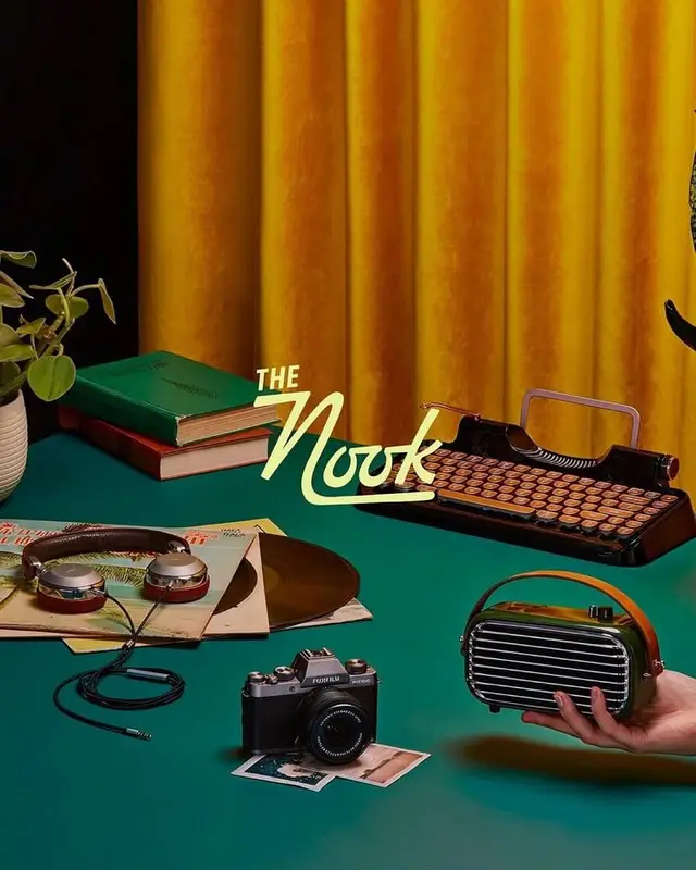 Retro still life: typewriter, radio, camera on teal tabletop