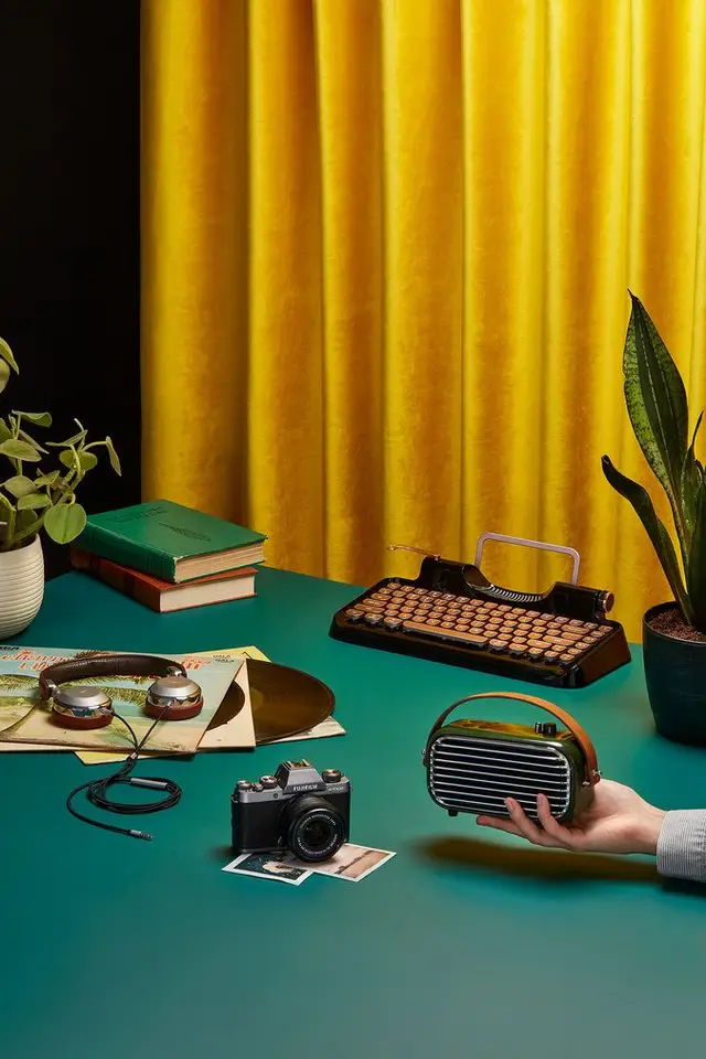 Retro still life: mustard velvet curtains, teal tabletop, vintage tech