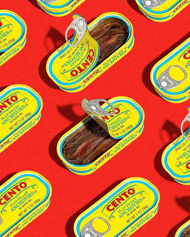 Cento anchovy tins repeated on bright red background