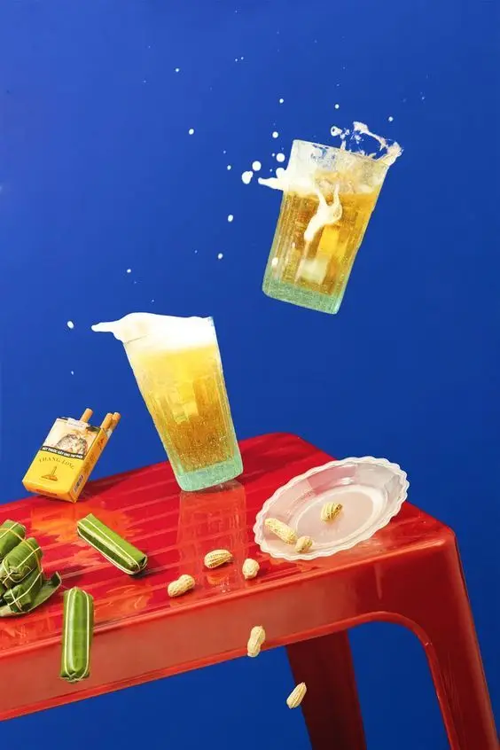 Levitation still life: frothy beer splash over red table