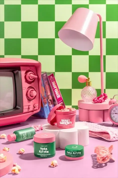 Pastel retro still life with 'Yoga Kitten' skincare jars and pink CRT TV