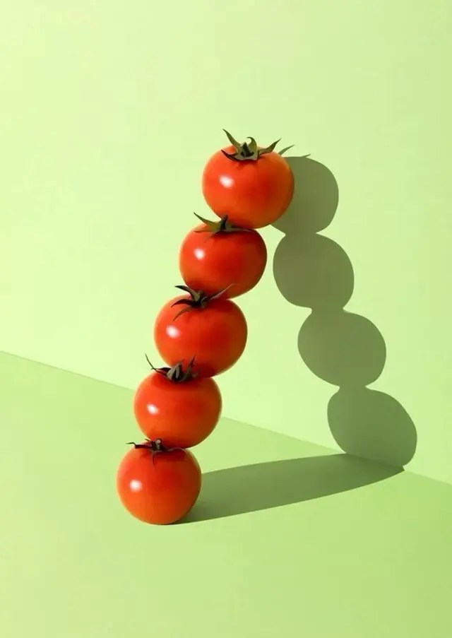 Stacked Cherry Tomatoes on Pale Green Backdrop