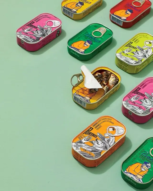 Colorful Porthos sardine tins flatlay on mint background