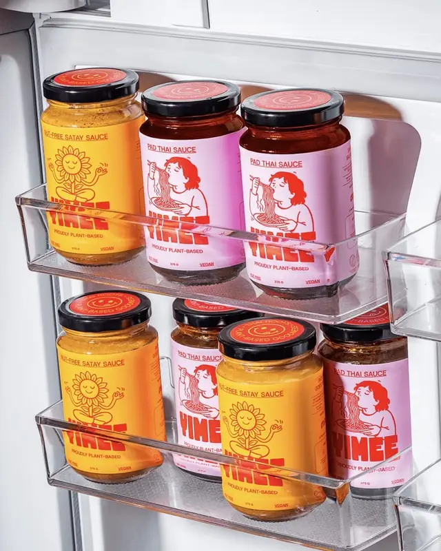 Pink Pad Thai and Yellow Nut‑Free Satay Sauce Jars on Fridge Door Shelf