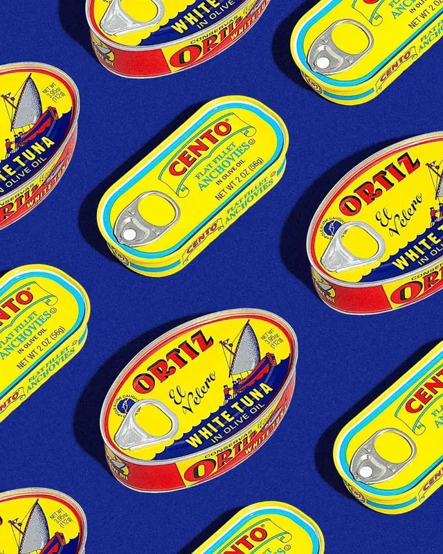 Cento & Ortiz anchovy and white tuna tins on cobalt blue background