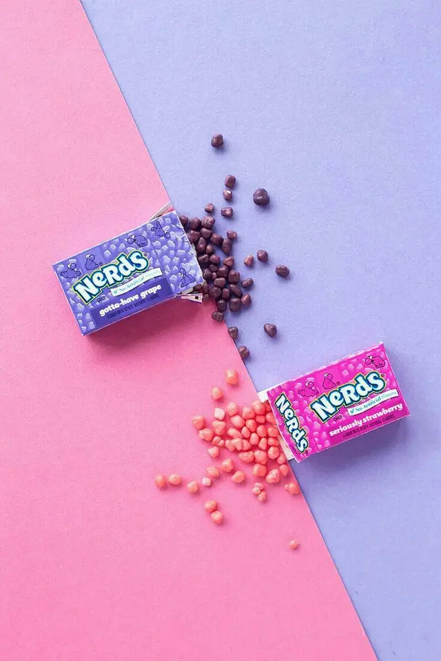 Nerds candy boxes on diagonal pastel pink and lavender background