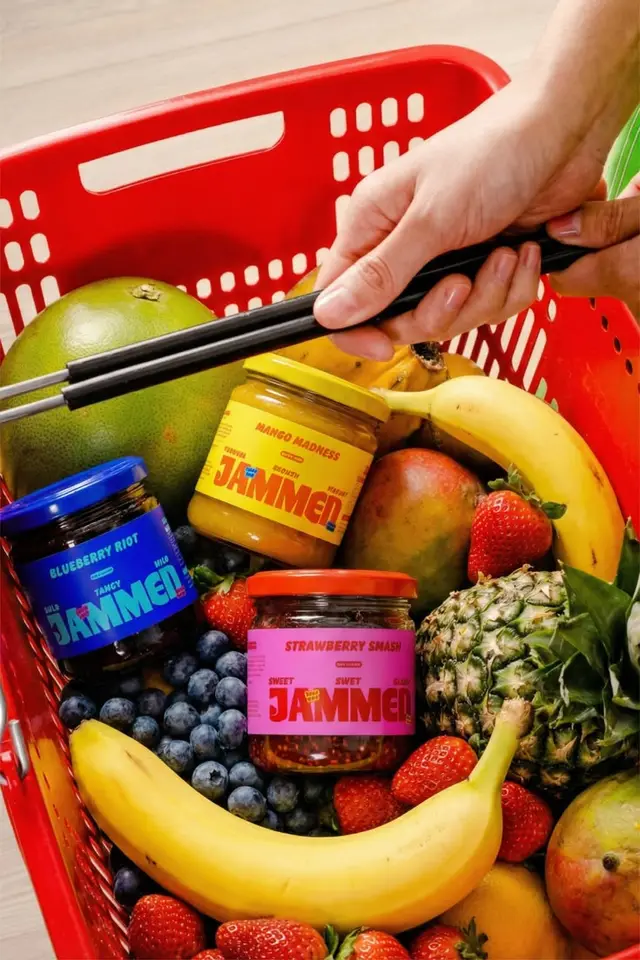 JAMMED jam jars (Blueberry Riot, Mango Madness, Strawberry Smash) in red grocery basket