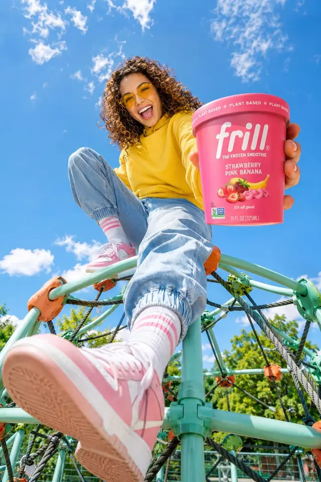 Frill Strawberry Pink Banana frozen smoothie tub — bright playground lifestyle ad