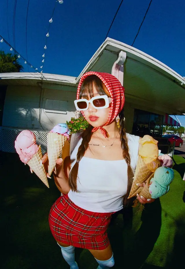 Young person in red gingham headscarf holding five pastel ice cream cones at a retro drive