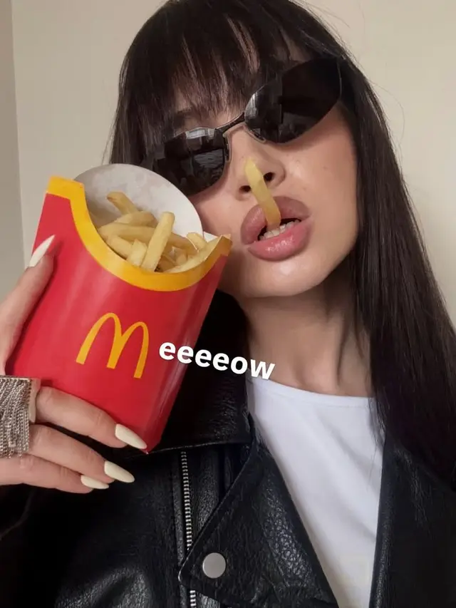 Edgy fashion selfie with McDonald's fries and cat-eye sunglasses