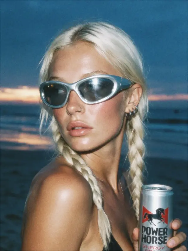 Beach portrait at sunset with Power Horse energy can and silver cat-eye sunglasses